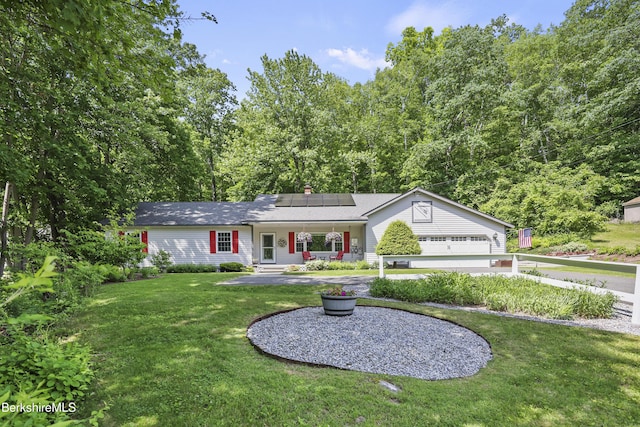 83 Bradley St, North Adams, MA 01247 - ranch-style home featuring covered porch, roof mounted solar panels, a front lawn, and a garage