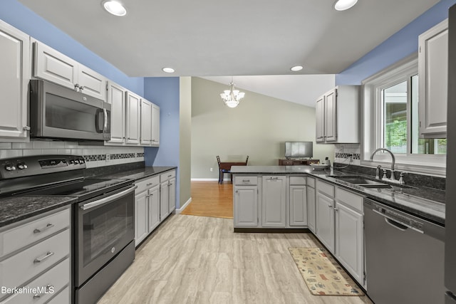 83 Bradley St, North Adams, MA 01247 - kitchen with stainless steel appliances, recessed lighting, a chandelier, a peninsula, and backsplash