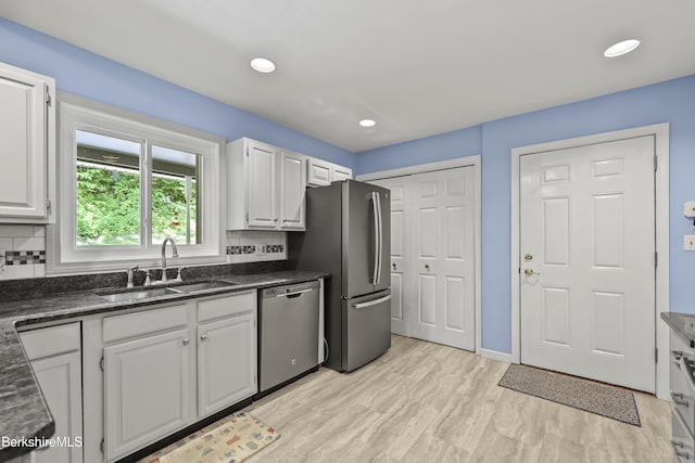 83 Bradley St, North Adams, MA 01247 - kitchen featuring appliances with stainless steel finishes, white cabinets, light wood-style floors, backsplash, and recessed lighting