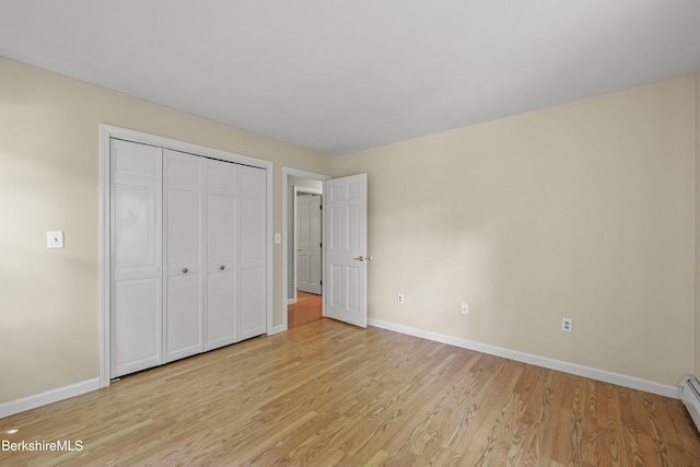 83 Bradley St, North Adams, MA 01247 - unfurnished bedroom featuring light wood-style floors, a closet, and baseboard heating