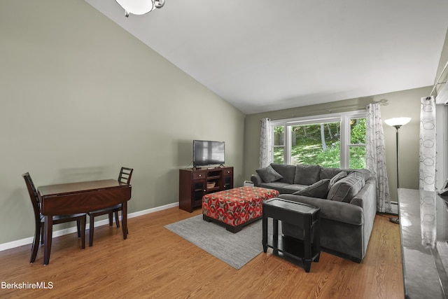 83 Bradley St, North Adams, MA 01247 - living area with wood finished floors, lofted ceiling, and a baseboard heating unit