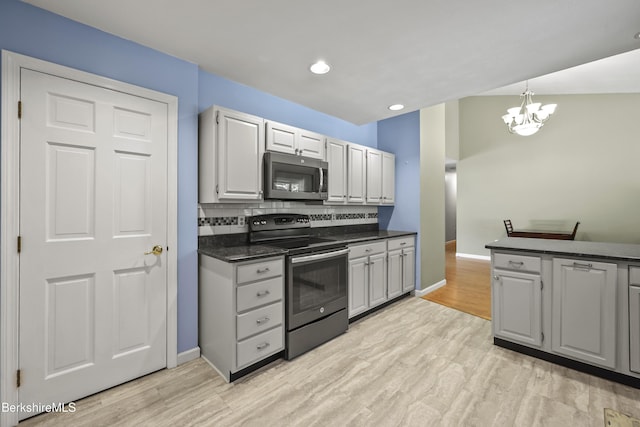 83 Bradley St, North Adams, MA 01247 - kitchen with stainless steel appliances, dark countertops, light wood-type flooring, backsplash, and recessed lighting