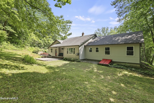 83 Bradley St, North Adams, MA 01247 - rear view of property featuring a yard, a patio, and a chimney