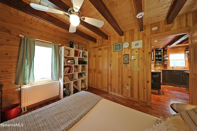 235 Algerie Rd, Becket, MA 01223 - bedroom with radiator, wooden walls, wood finished floors, and a wood ceiling with exposed beams