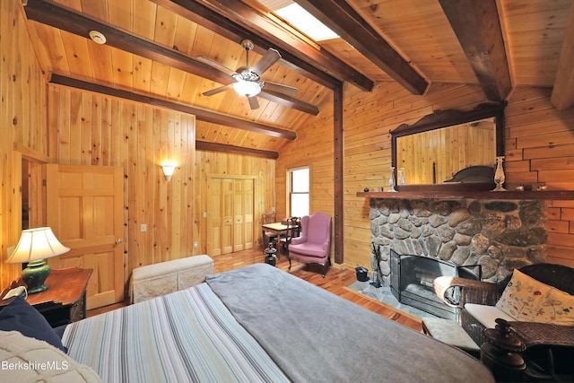 235 Algerie Rd, Becket, MA 01223 - bedroom with wood walls, wood finished floors, and a fireplace