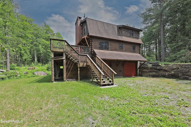 235 Algerie Rd, Becket, MA 01223 - rear view of house featuring stairs, a chimney, a wooden deck, an attached garage, and a lawn