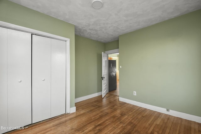 23 Ashton St, Worcester, MA 01604 - unfurnished bedroom featuring baseboards, a closet, and wood-type flooring