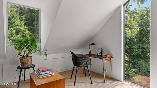 office area featuring light carpet and lofted ceiling