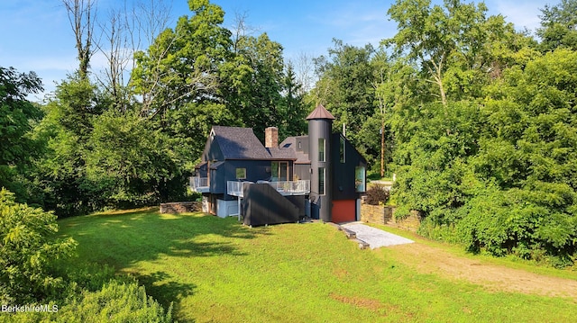 exterior space featuring a chimney and a front lawn