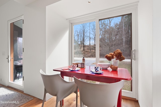 dining space with wood finished floors