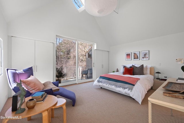 carpeted bedroom with multiple windows, access to exterior, high vaulted ceiling, and a skylight