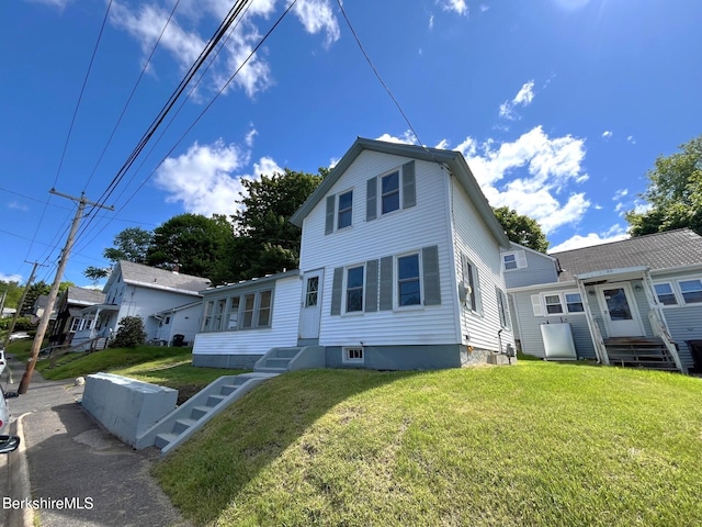 22 Marietta St, North Adams, MA 01247 - traditional-style home featuring entry steps and a front lawn
