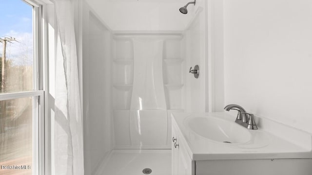 full bathroom featuring vanity and walk in shower