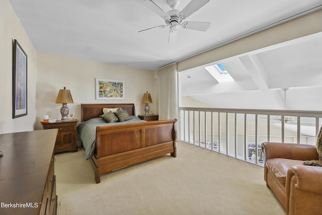 carpeted bedroom featuring ceiling fan and a skylight