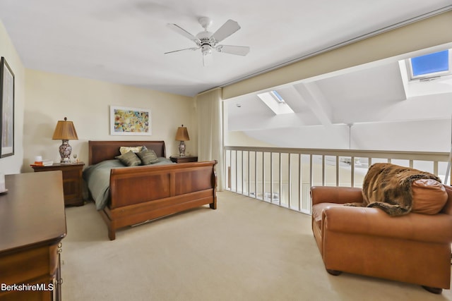 bedroom with light carpet, ceiling fan, and a skylight