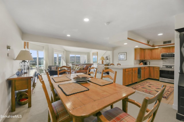 dining room with light colored carpet