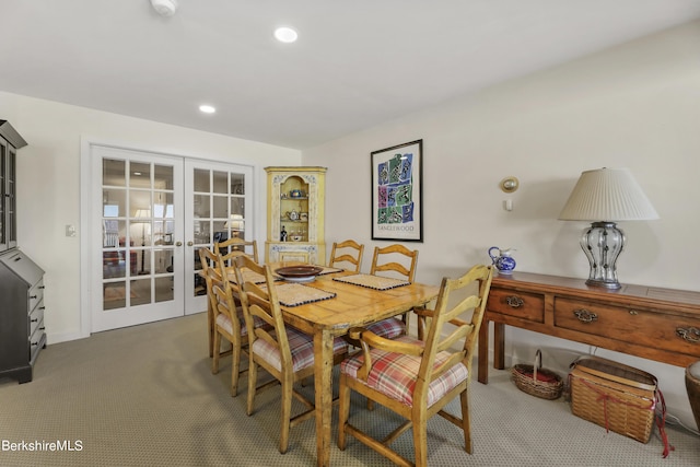 dining space with dark carpet and french doors