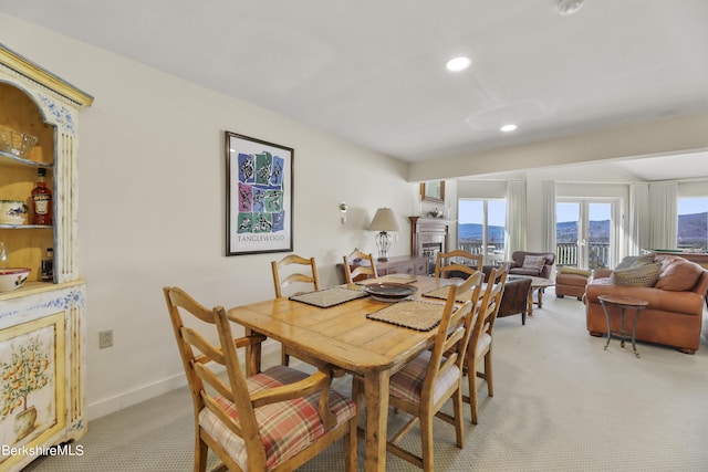 dining area with light colored carpet