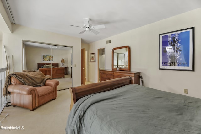 carpeted bedroom featuring ceiling fan and a closet