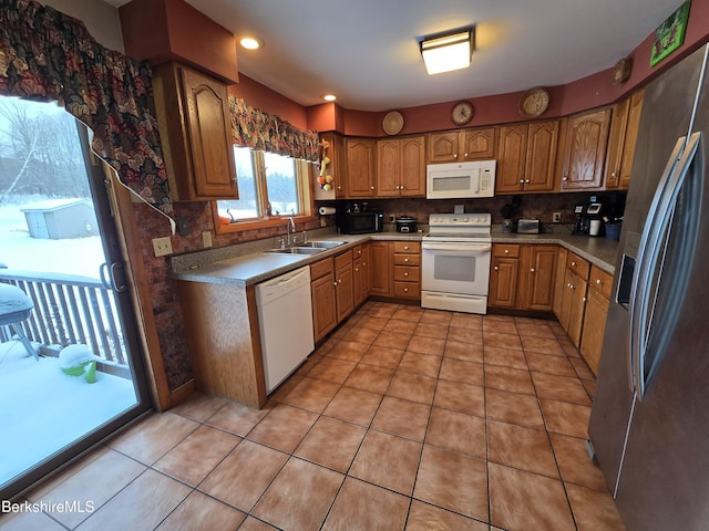 kitchen with light tile patterned flooring, white appliances, tasteful backsplash, and sink