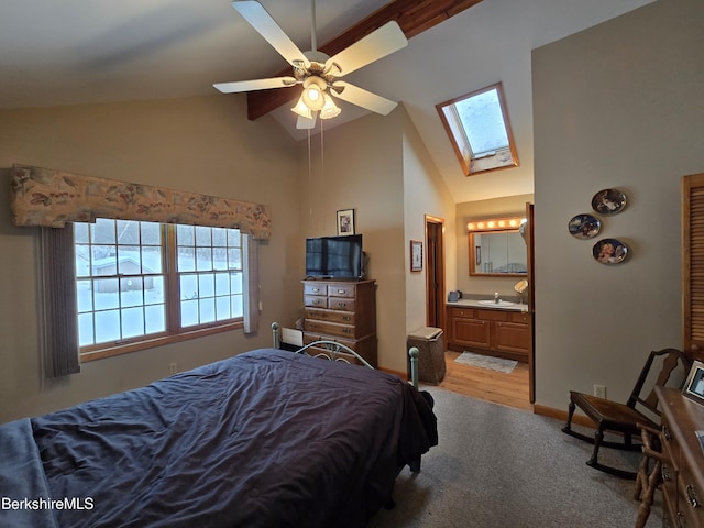 bedroom with light colored carpet, ceiling fan, sink, high vaulted ceiling, and connected bathroom