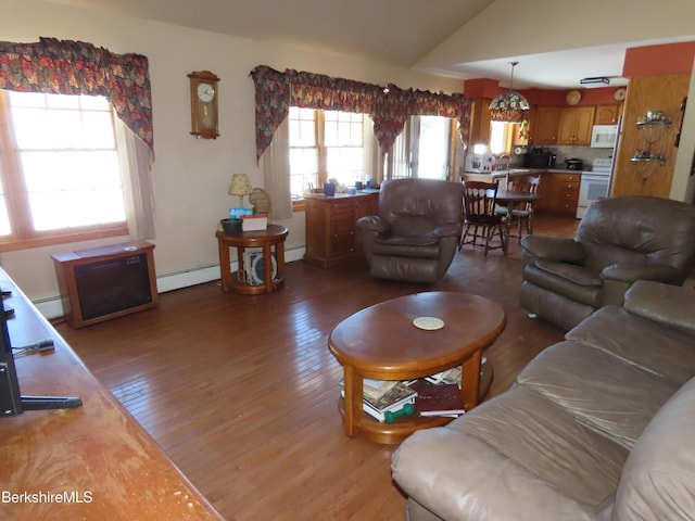 living room featuring a baseboard radiator, a baseboard heating unit, vaulted ceiling, and light wood finished floors