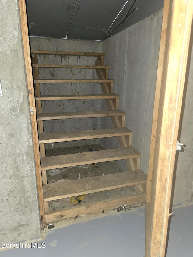 stairway with concrete floors