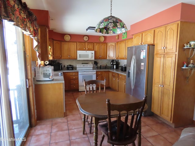 kitchen featuring tasteful backsplash, a healthy amount of sunlight, white appliances, and light countertops