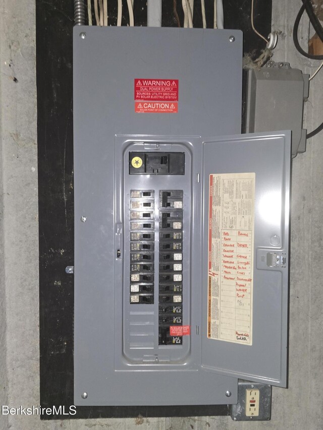 unfinished basement featuring water heater, stairway, and electric panel