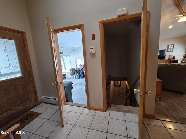 foyer featuring light tile patterned floors, french doors, baseboard heating, and ceiling fan