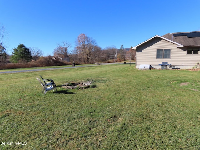 view of yard with a fire pit