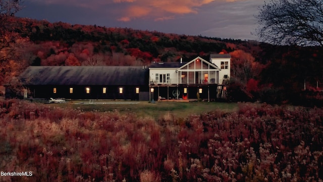 back house at dusk with a deck