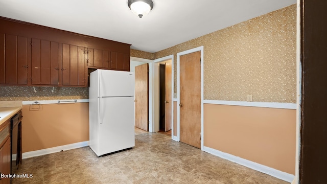 202 Park Ave, Dalton, MA 01226 - kitchen featuring freestanding refrigerator, light countertops, and brown cabinets