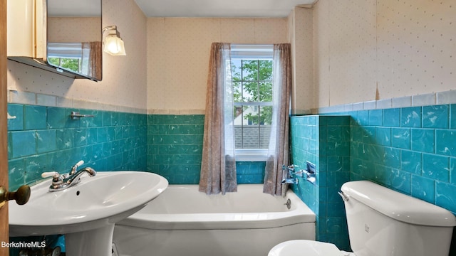 202 Park Ave, Dalton, MA 01226 - full bathroom featuring tile walls, wallpapered walls, a bathtub, and wainscoting