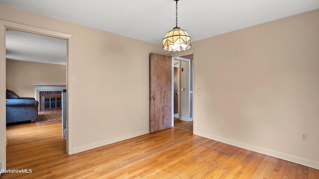 202 Park Ave, Dalton, MA 01226 - spare room featuring light wood finished floors and a fireplace