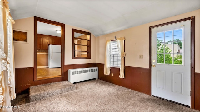 202 Park Ave, Dalton, MA 01226 - entrance foyer featuring radiator heating unit, wainscoting, vaulted ceiling, carpet flooring, and wood walls