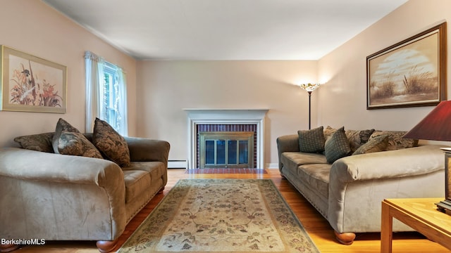 202 Park Ave, Dalton, MA 01226 - living room featuring wood finished floors, a baseboard radiator, and a fireplace