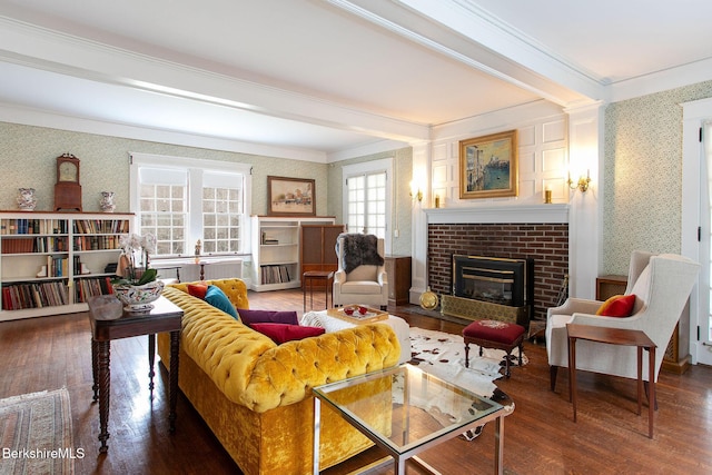 living area featuring a brick fireplace, wood finished floors, ornamental molding, and wallpapered walls