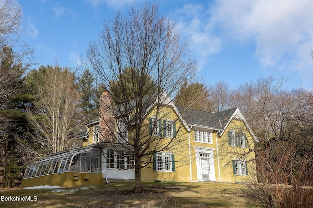 view of front of home featuring a carport and a chimney