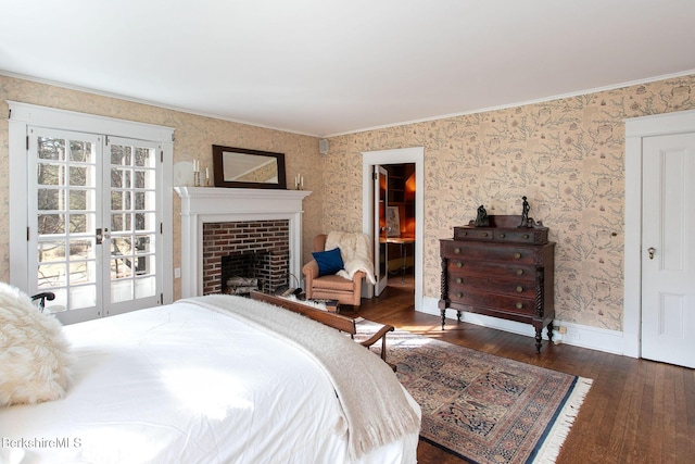 bedroom with french doors, wood-type flooring, a fireplace, wallpapered walls, and baseboards