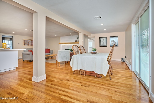 23 Pine St, Otis, MA 01253 - dining space featuring light wood finished floors, a fireplace, baseboard heating, recessed lighting, and a baseboard heating unit