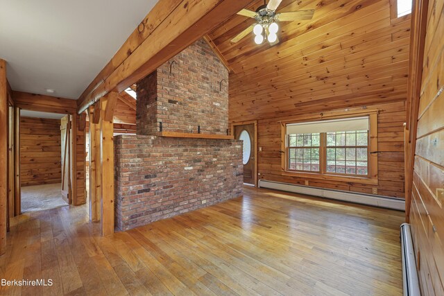 189 Cross Place Rd, Washington, MA 01223 - unfurnished living room with a baseboard radiator, hardwood / wood-style flooring, wood walls, beamed ceiling, and a ceiling fan