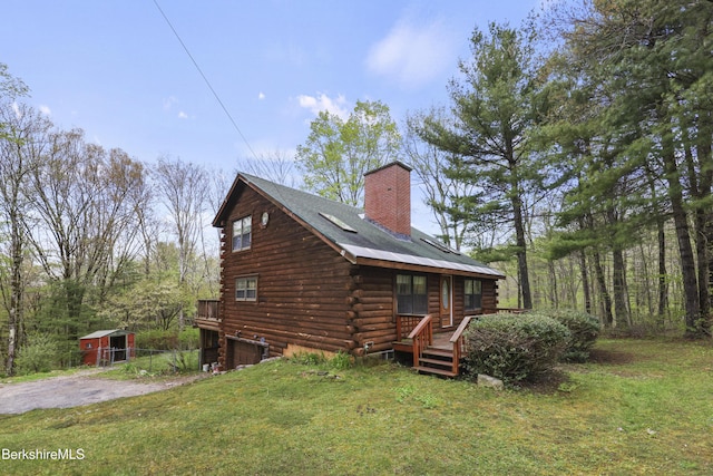 189 Cross Place Rd, Washington, MA 01223 - view of property exterior featuring log siding, a chimney, a lawn, and an outbuilding