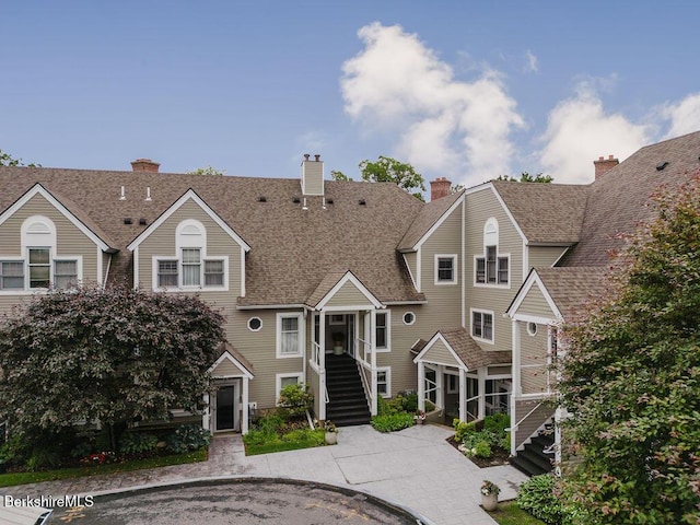 80 Taconic Ave # 14, Great Barrington, MA 01230 - view of front facade featuring a shingled roof, a chimney, and stairs