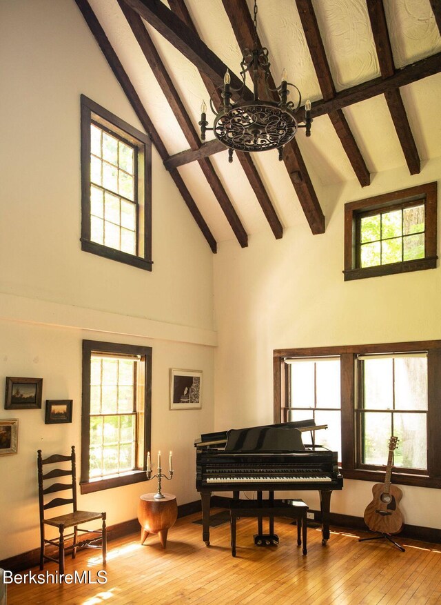 9 Yale Hill Rd, Stockbridge, MA 01262 - sitting room with a chandelier, high vaulted ceiling, beamed ceiling, light wood-style flooring, and baseboards