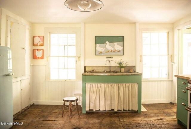 9 Yale Hill Rd, Stockbridge, MA 01262 - kitchen featuring green cabinetry, dark wood-style flooring, freestanding refrigerator, baseboards, and wainscoting