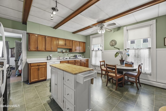 kitchen with plenty of natural light, dishwasher, brown cabinetry, and light countertops