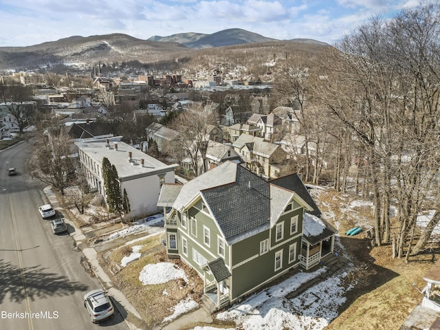 snowy aerial view featuring a mountain view