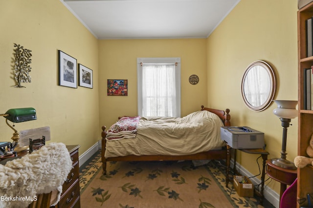 bedroom featuring baseboards, carpet floors, and crown molding