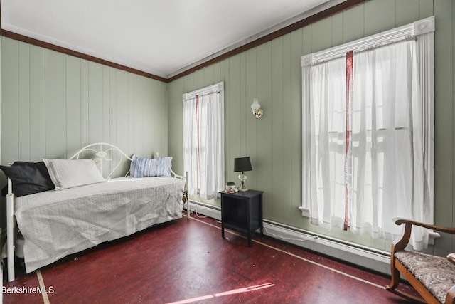 bedroom featuring multiple windows and baseboard heating